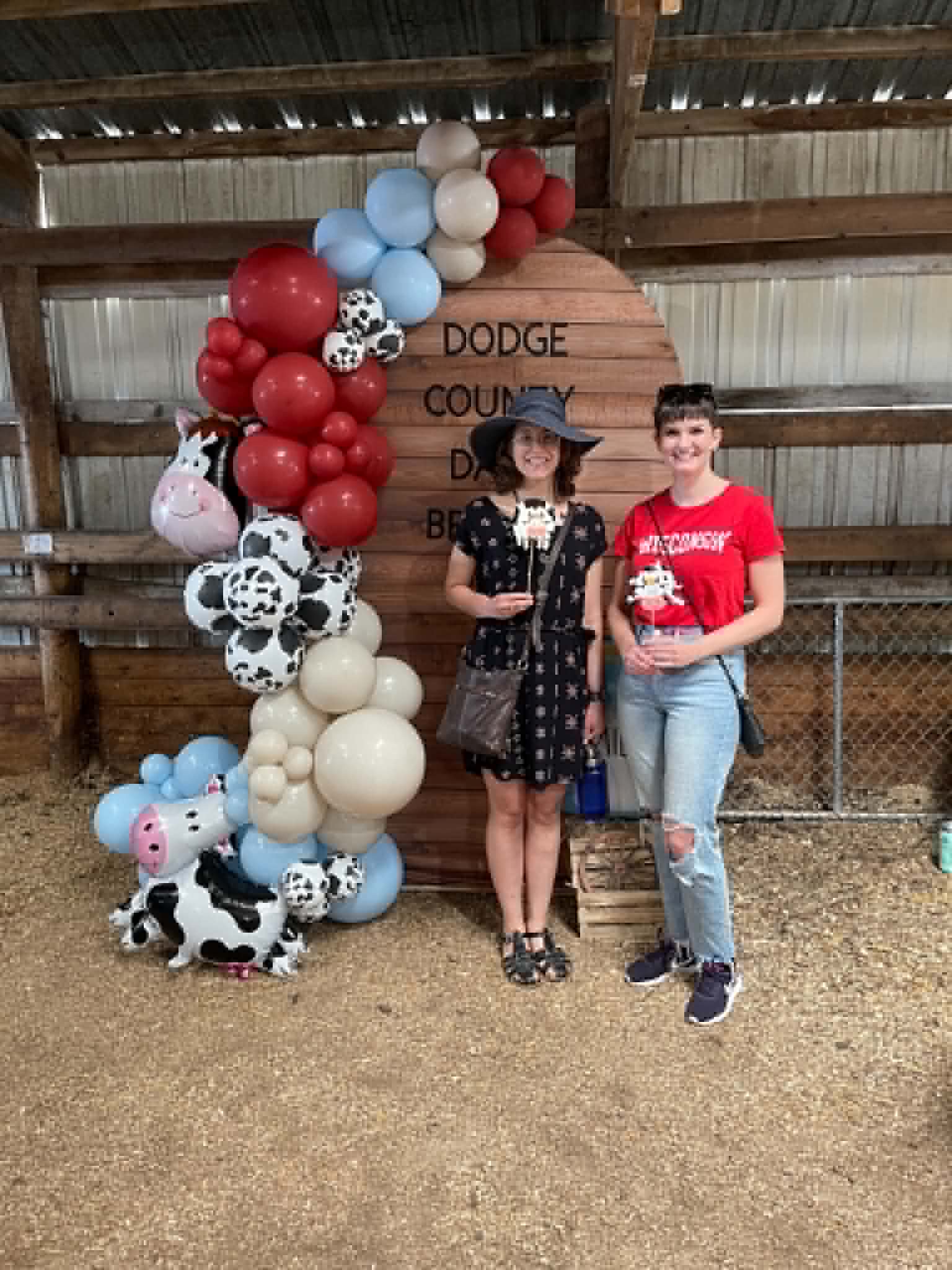 Guests posing by Corrales Designs Dodge County Dairy Brunch balloon arch